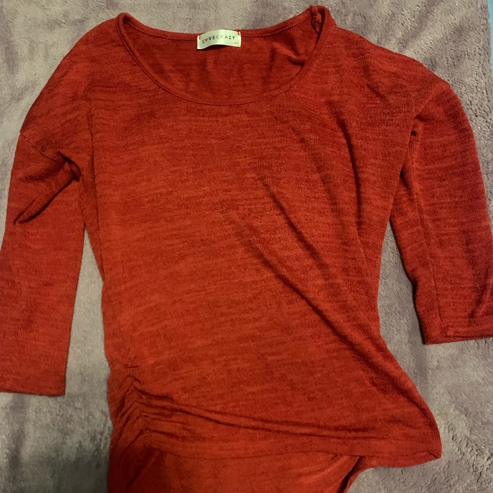 Vibrant red sweater. Has a cute design on the side